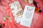 Invitatii nunta cu liliac si fluturi pe un carton crem